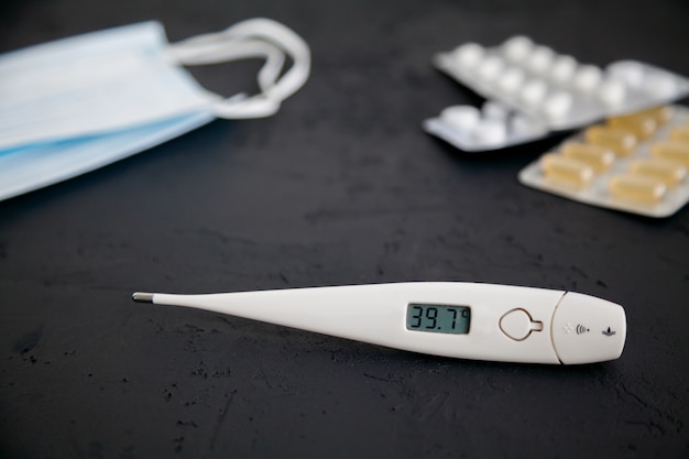 Thermometer 39.7, medicines and protective masks