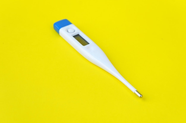 Thermometer isolated on yellow background