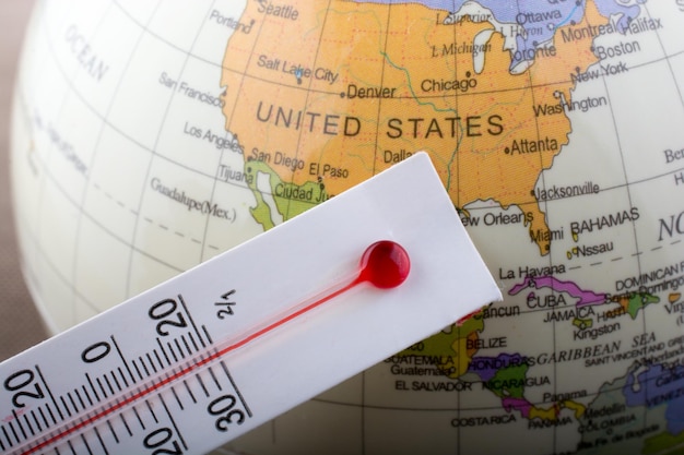 Thermometer placed on a little model globe