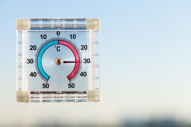 Thermometer on window and blue sky in hot twilight