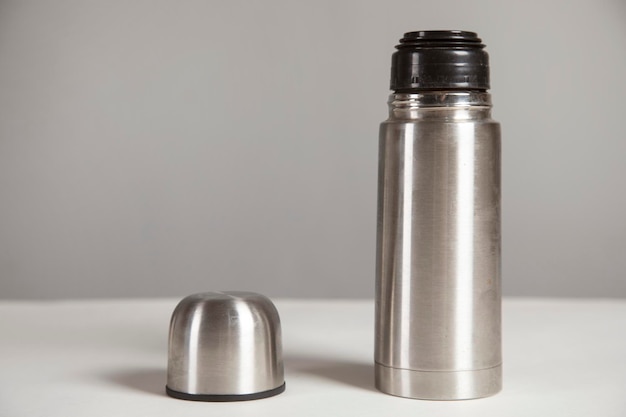 Photo thermos bottle on the table