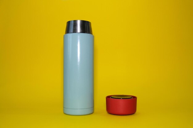 Thermos on a bright yellow background high quality photo