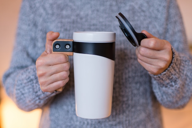 Thermos Travel Mug, White Tumbler Cup,  Flask for Tea or Coffee in woman hands