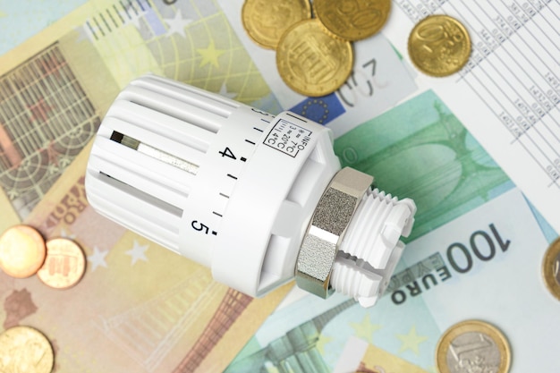 Thermostatic Valve Head on Euro Banknotes Background Increasing Consumption Cost of Electricity and Expensive Energy Concept Price Hike Heating Crisis Utility Bill Saving Conservation Inflation