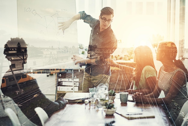 They are right on track. Multiple exposure shot of a business group superimposed over a train track.