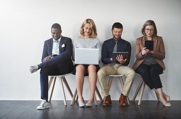 Photo they were all shortlisted they are experienced in the job studio shot of businesspeople waiting in line against a white background