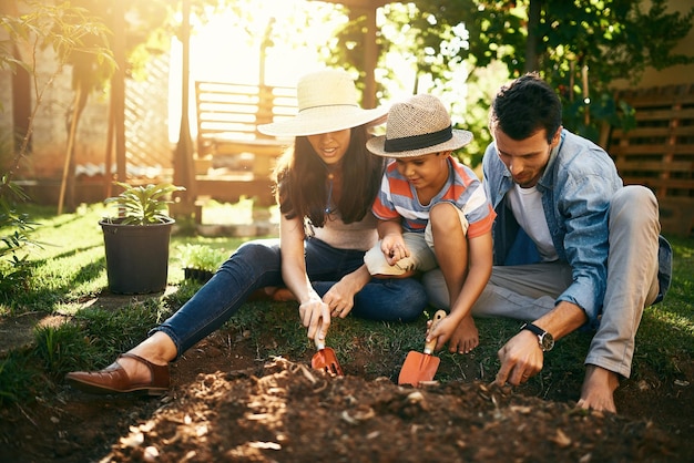 Theyre all about growing their own Shot of a family gardening together in their backyard