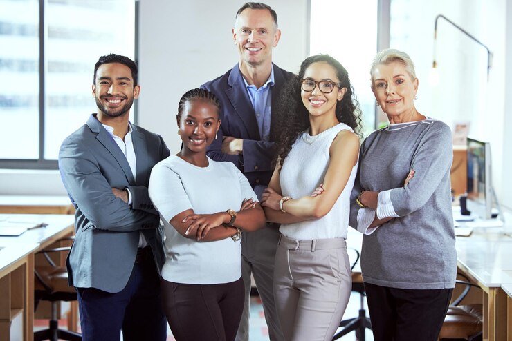 Photo theyre all about their business shot of a group of businesspeople standing in an office at work