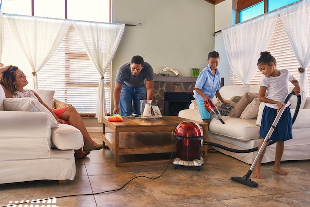 Theyre all lending a helping hand Shot of a family cleaning around the house