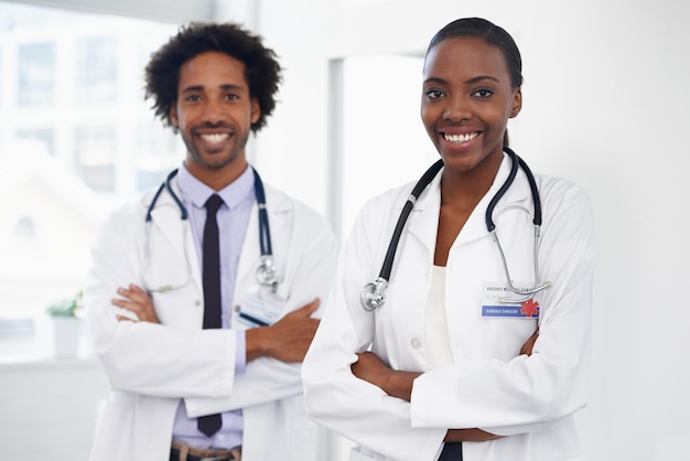 Theyre dedicated to medicine Portrait of two doctors standing in a room