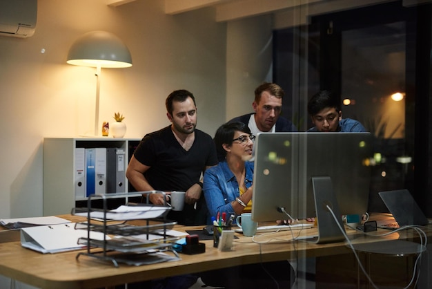 Theyre driven to succeed together Shot of employees working in an office at night