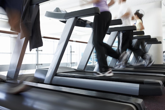 And theyre off Cropped shot of a people running on the treadmills at the gym