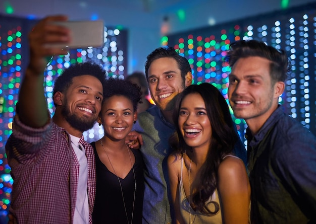 Theyve made it a night to remember Cropped shot of a group of friends taking a selfie while partying in a club