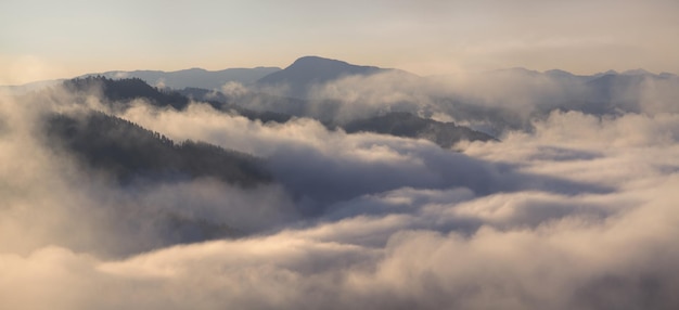 A thick fog covered the mountains a top view banner background