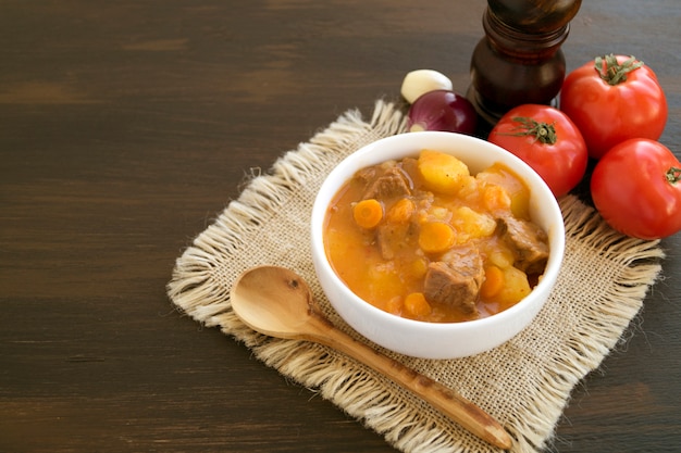 Thick Hungarian soup, the goulash. on dark background.