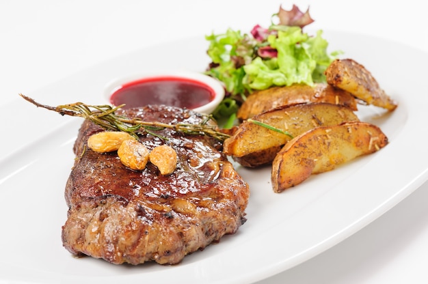 Thick juicy beef steak with potato and salad