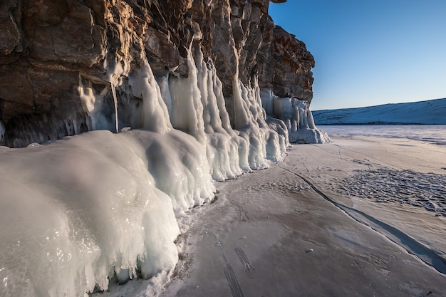 Thick layer of ice on rock lit by the sun