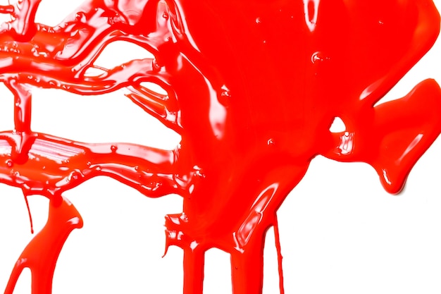 Thick red paint on a white background. Paint flows