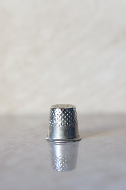 Thimble on light background with copy space