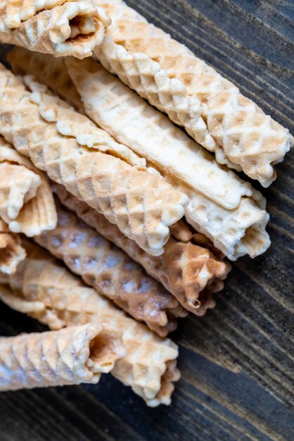 Thin crispy waffles lie on a black table sweet food for desserts