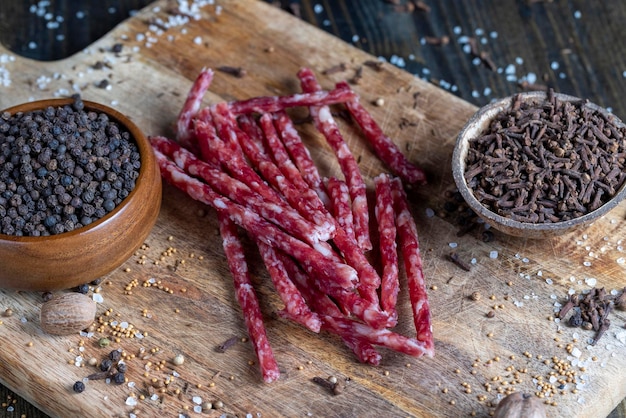 Thin dried meat sausages with spices close up