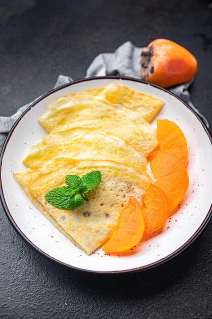 thin pancake persimmon crepe Shrovetide holiday Maslenitsa sweet dessert breakfast pancakes food 