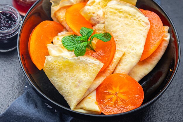 thin pancake persimmon crepe Shrovetide holiday Maslenitsa sweet dessert breakfast pancakes food 