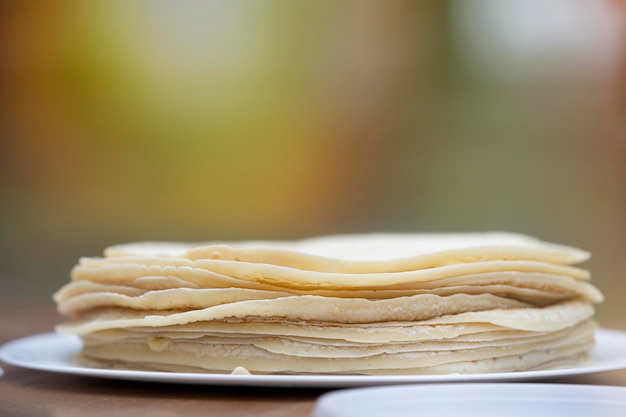 Thin pancakes stacked on a plate