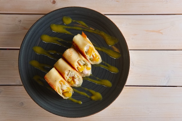 Photo thin pancakes with chicken and pineapple