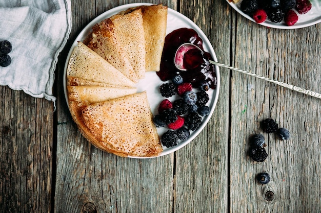 Thin Pancakes with jam and berries. Breakfast. Maslenitsa holiday