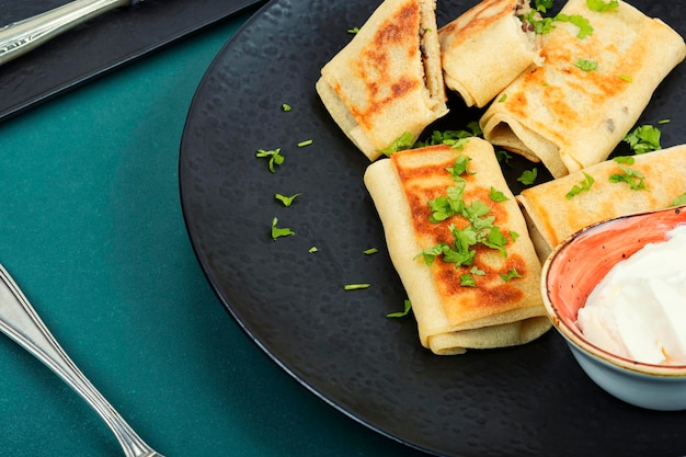 thin pancakes with meat fillings