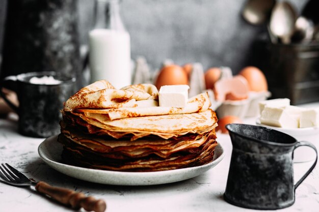 Thin pancakes with milk in a plate. crepes