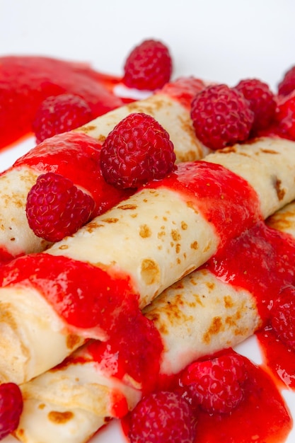 Thin pancakes with sweet raspberries and berry sauce