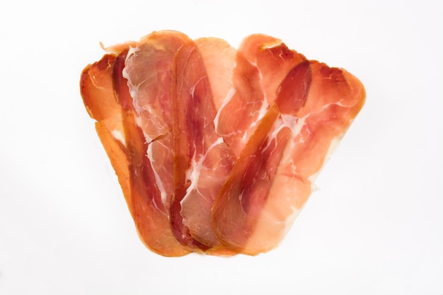 Thin slices of spanish serrano ham isolated on white surface