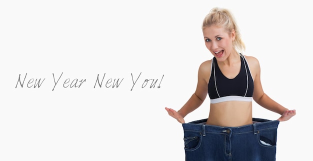 Photo thin woman wearing old pants after losing weight