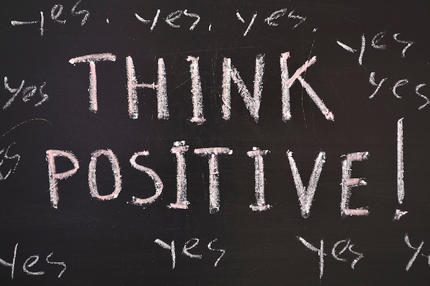 Think positive, quote on blackboard