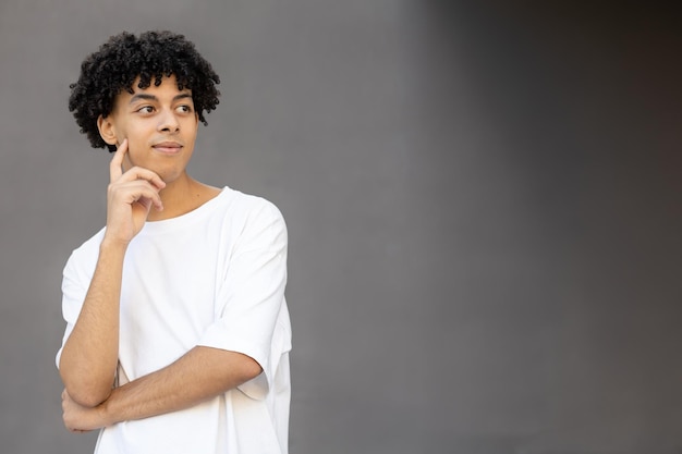 Photo thinking american guy with crossed arms wearing a white tshirt