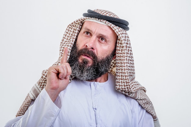 Thinking arabic man posing on white background.