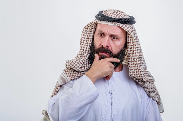 Thinking arabic man posing on white background.