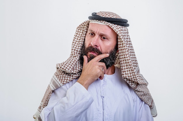 Thinking arabic man posing on white background.