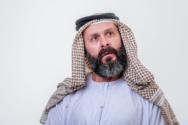 Thinking arabic man posing on white background.