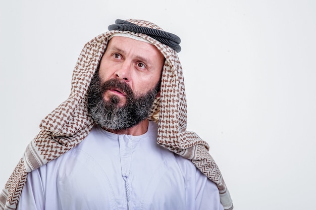 Thinking arabic man posing on white background.