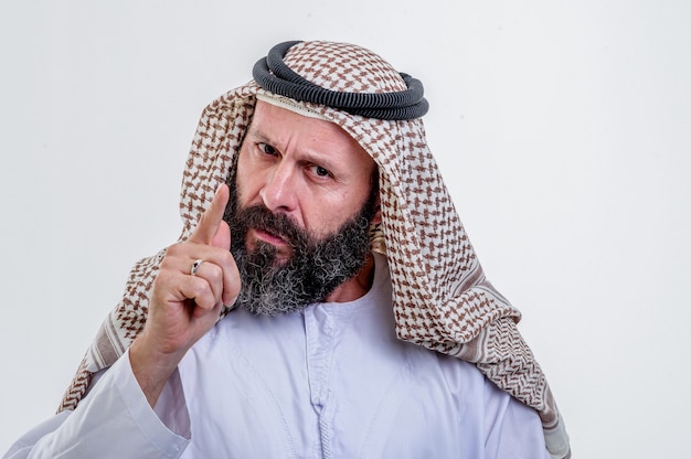 Thinking arabic man posing on white background.