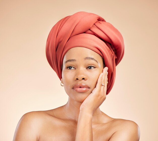 Thinking beauty and black woman in studio with hair scarf idea or natural cosmetic questions on brown background Face skincare and African lady model with head wrap wellness or glow treatment