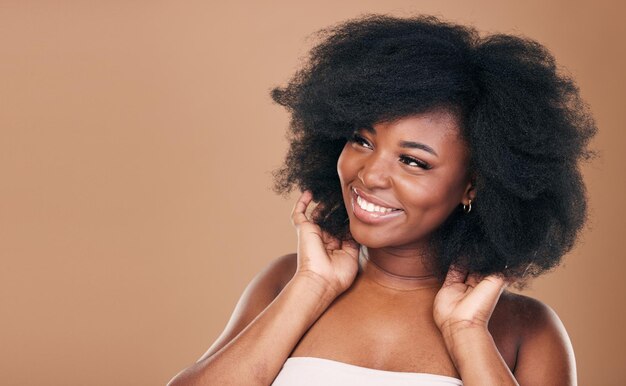 Thinking black woman and hair care for afro growth and natural beauty on a brown studio background Ideas hairstyle and African model with cosmetics after salon treatment texture and mockup space