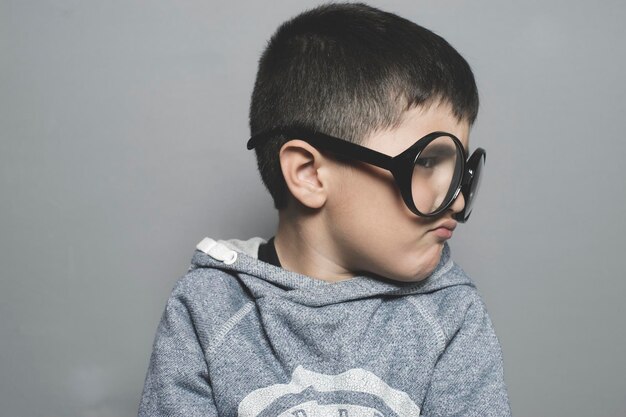 thinking, boy with big glasses very serious and thinking