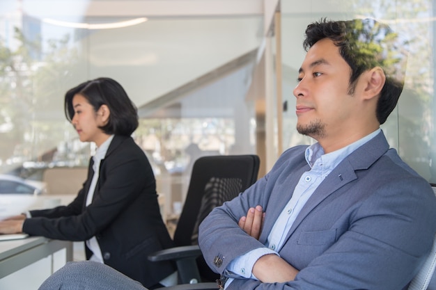 Photo thinking business during meeting in office. thai businessman looking forward,twopeople.