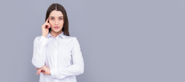 Thinking businesslady in white shirt on grey background ceo Woman isolated face portrait banner with mock up copy space