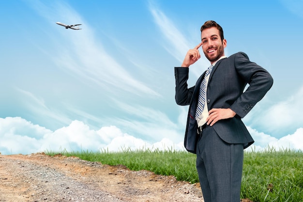 Thinking businessman against road leading out to the horizon