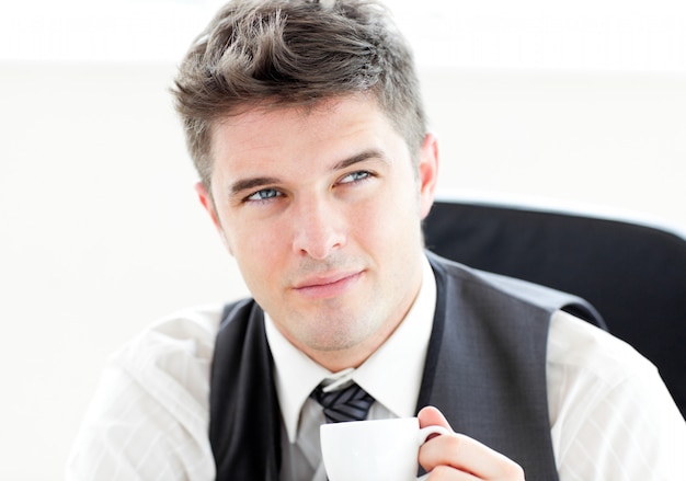 Thinking businessman drinking coffee